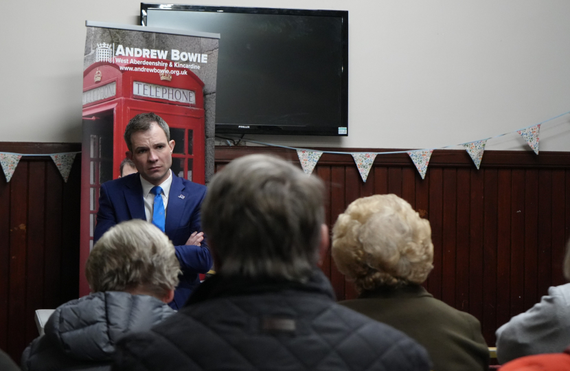 Andrew Bowie MP stands at the front of a crowd listen to local residents voice their concerns on local issues. 