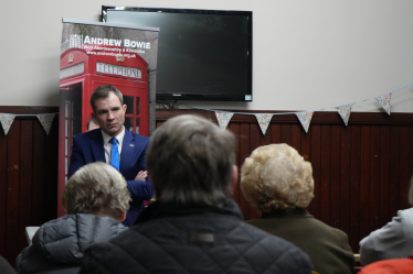 Andrew Bowie MP stands at the front of a crowd listen to local residents voice their concerns on local issues. 